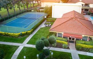 Leasing office and tennis court aerial view at Woodbend, Alta Loma, CA