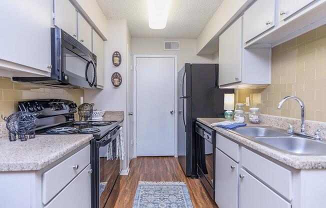 a kitchen with a stove sink and refrigerator