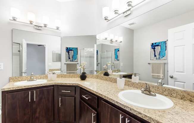 One K Apartments in Atlanta, GA photo of a bathroom with two sinks and a mirror