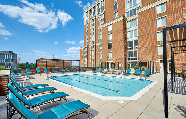 Soak up the sun at our newly renovated pool, featuring a shaded trellis, comfortable chaise lounges, and poolside dining tables.
