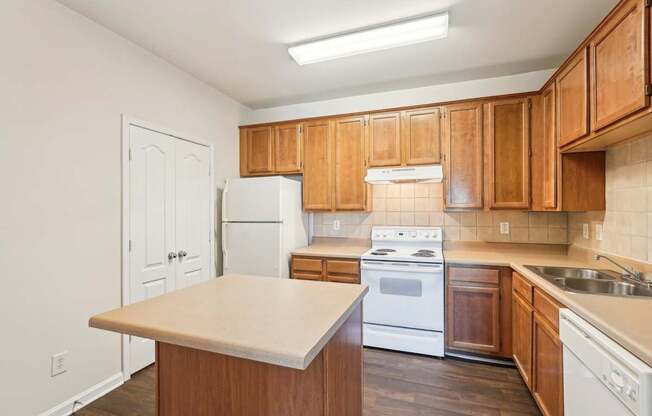A kitchen with wooden cabinets and white appliances.