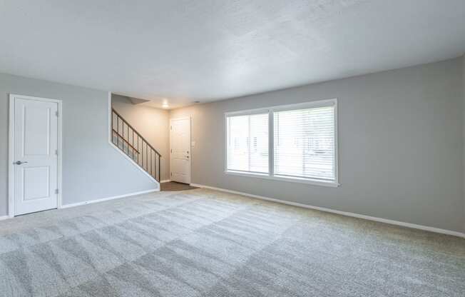 Spacious Living Room in the Three Bedroom Townhome at Woodbridge Apartments Bloomington