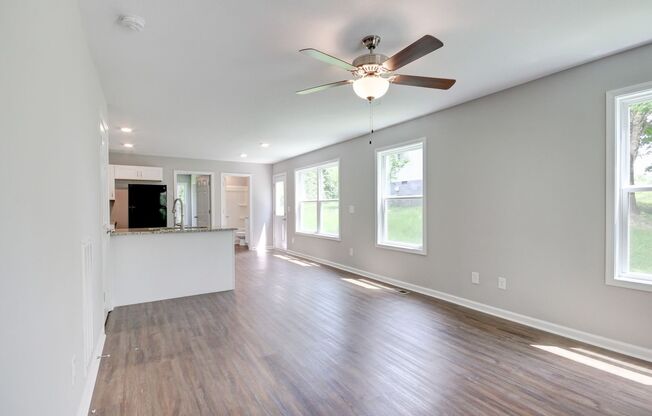 Two Story Duplex With Hardwood Flooring and White Cabinetry