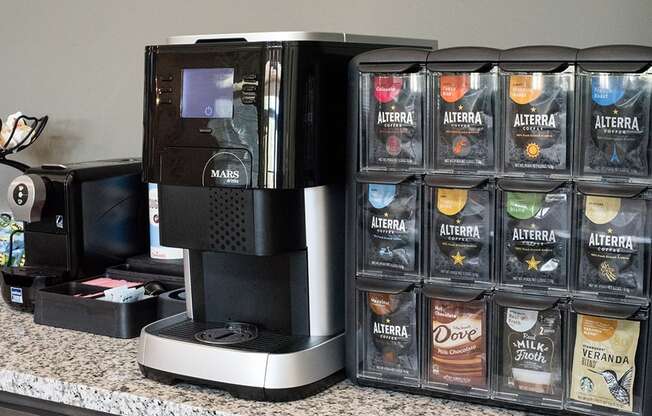 a coffee maker with several containers of coffee on a counter