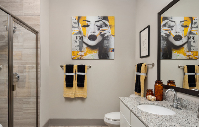 Model bathroom at our apartments for rent in Atlanta, featuring granite countertops and modern decor.