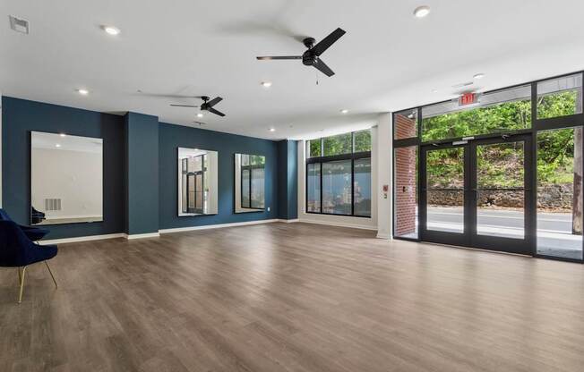 A room with a ceiling fan and a chair.