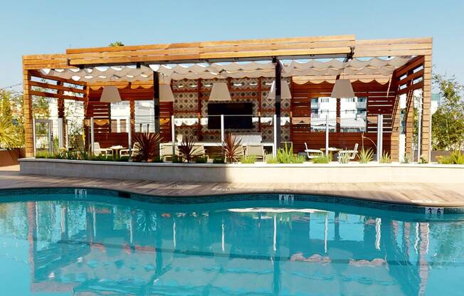 Vacation mode with this poolside kitchen and bar