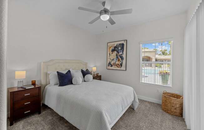 a bedroom with a bed and a ceiling fan