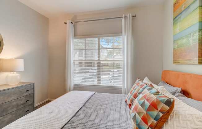a bedroom with a large bed and a window