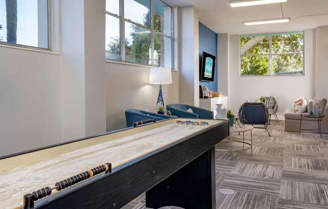 A room with a pool table and a chair.