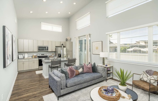 a living room and kitchen with a couch and a table at Grandstone at Sunrise, Peoria, AZ