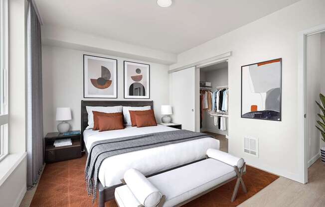 A bedroom with two beds and a white chair.