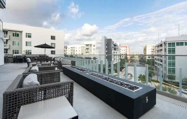 A black and white outdoor seating area with a long table and chairs.