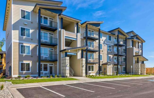 a large apartment building with a parking lot in front of it