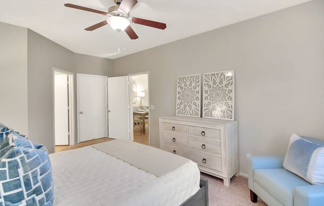 a bedroom with a large bed and a ceiling fan