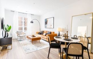 a living room with a round table and a couch at One Ten Apartments, Jersey City , New Jersey