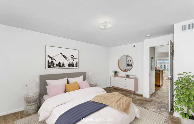 a bedroom with a bed and a mirror and a closet at Tall Oaks Apartment Homes, Michigan