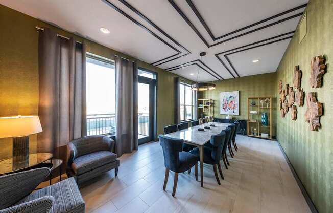 A dining room with a long table and chairs.