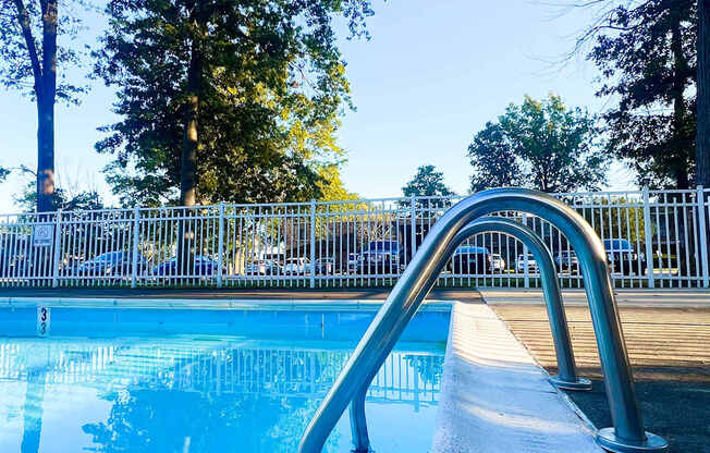 A pool with a metal ladder leading into the water.