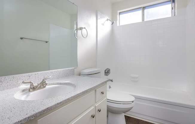 an empty bathroom with a sink toilet and shower