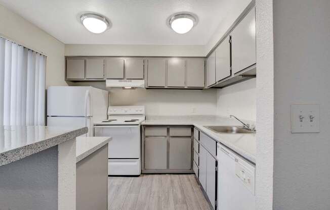 A kitchen with white appliances and a white refrigerator.