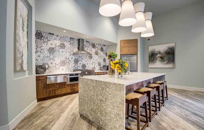 A kitchen with a counter and bar stools.
