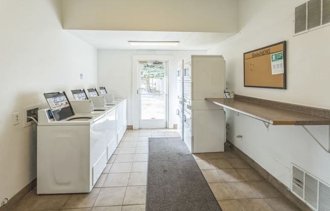 the laundry room is equipped with washers and dryers and a door to the