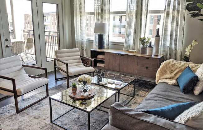 a living room filled with furniture and a glass table at GrandView Flats and Townhomes, Indiana