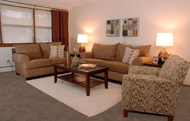 a living room with a couch chair and coffee table