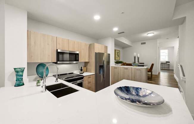 a kitchen with a white counter top and a sink