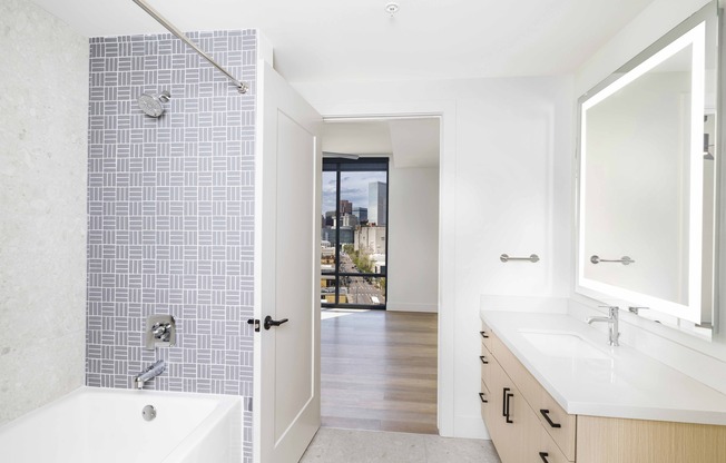 Step into luxury at Modera Golden Triangle. Discover designer bathrooms featuring quartz countertops and backlit mirrors, complemented by serene spa-like soaking tubs for your ultimate relaxation.