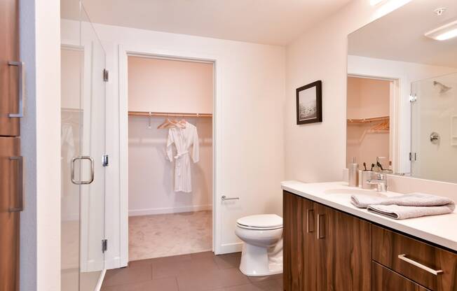 a bathroom with a toilet and a shower and a sink