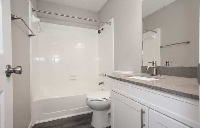 an empty bathroom with a sink toilet and shower