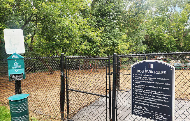 A sign that says Dog Park Rules stands in front of a fence.