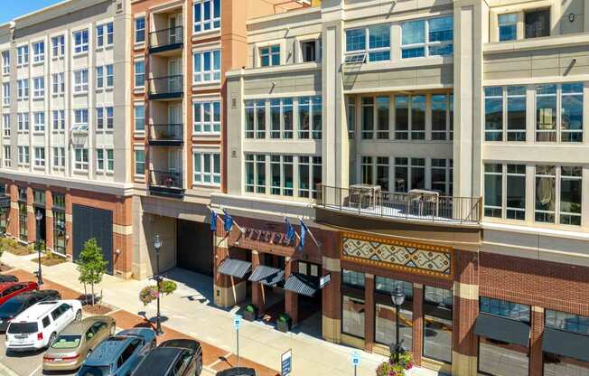 a view of a building from above with cars parked in front of it