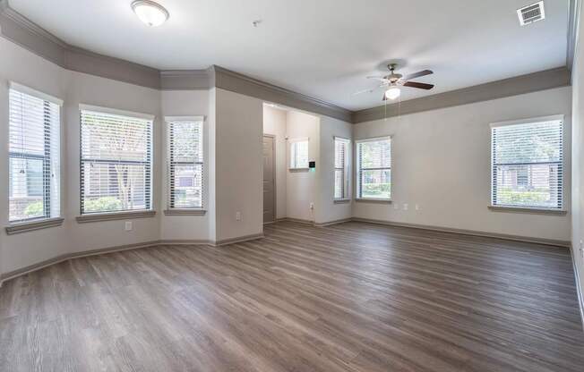 A room with wooden floors and a ceiling fan.