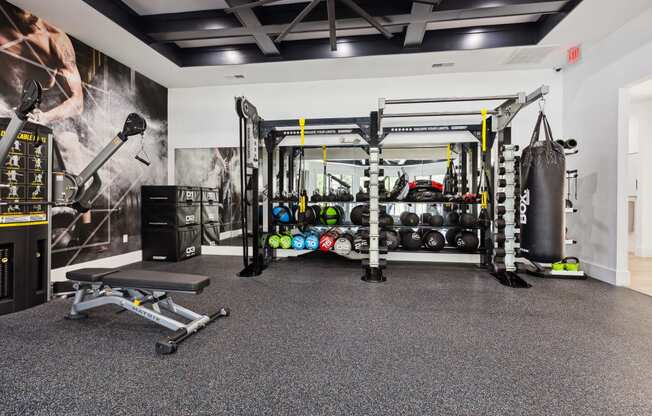 a home gym with a large amount of equipment and a bench