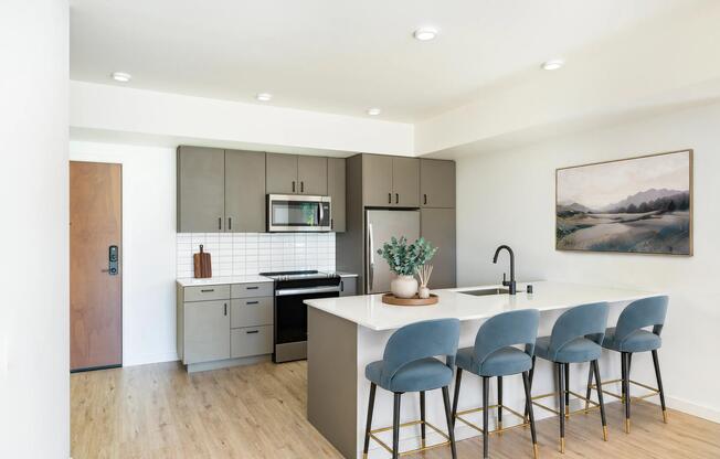 Premium homes feature oversized kitchen islands, built-in wine refrigerators, quartz countertops, and spacious open-concept layouts designed for elevated living and entertaining.