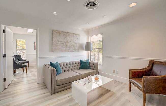 A living room with a grey couch and a coffee table.