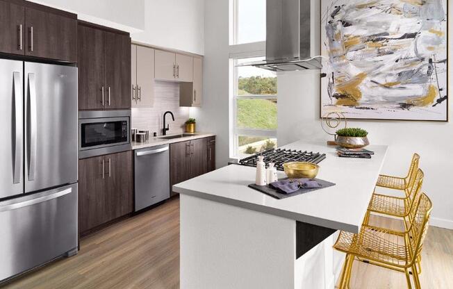 a kitchen with stainless steel appliances and a white counter top