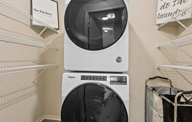 A white Whirlpool washing machine and dryer in a laundry room.