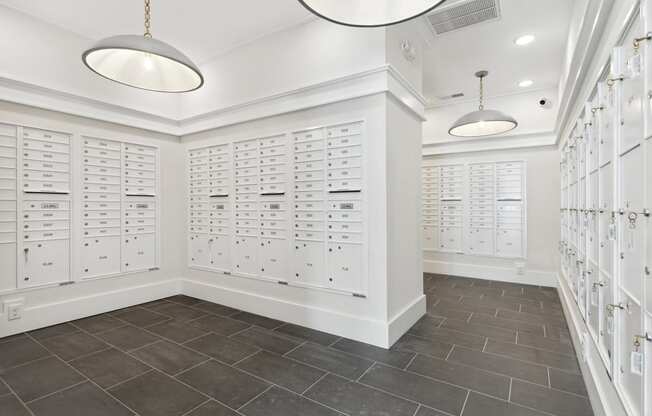 a locker room with white lockers and two lights