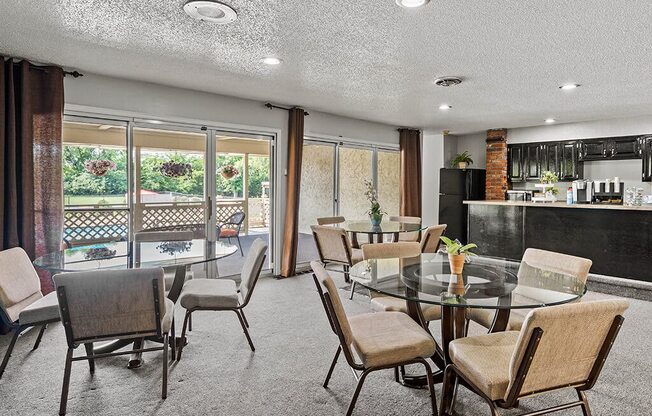 a dining room with a glass table and chairs