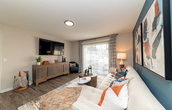 Spacious living room with hardwood-style flooring and overhead lighting