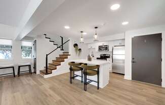 A modern kitchen with a dining table and chairs.