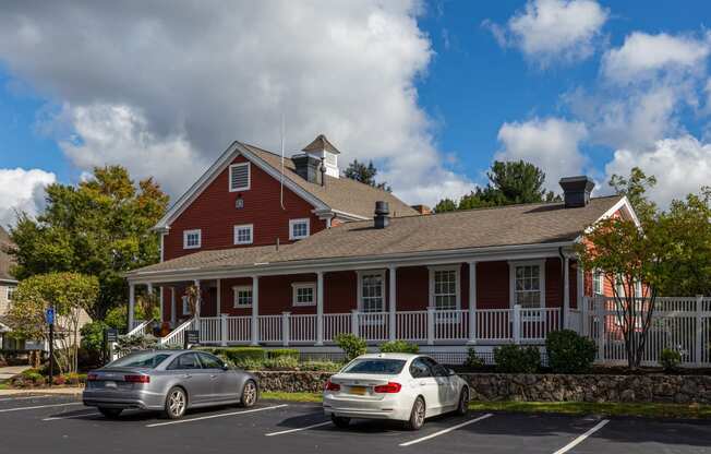 Orchards Apartments Marlborough ma apartment loft style apartments photo of clubhouse exterior with red siding and white rails next to parking lot