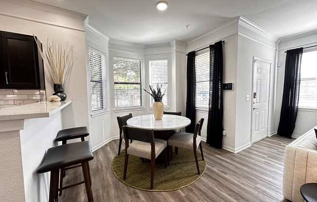 a kitchen and dining room with a table and chairs