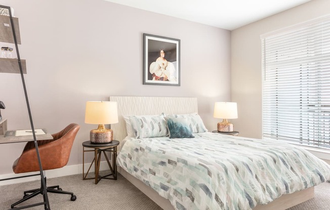 a bedroom with a bed and a desk with a chair