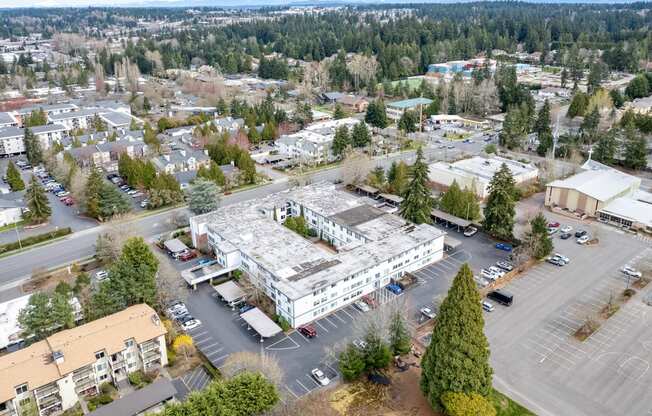 an aerial view of a large building in a parking lot