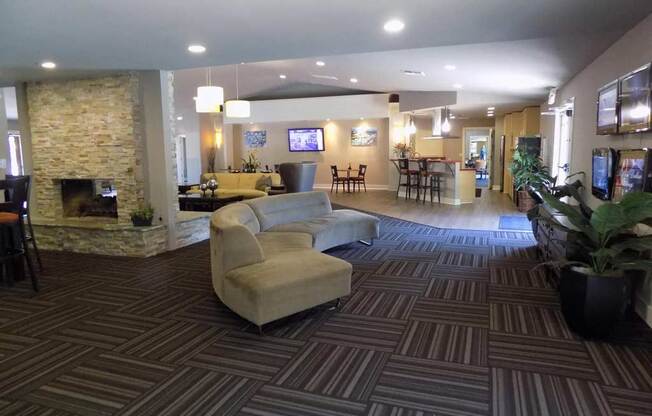 Downtown Sacramento Apartments for Rent-The Palms-Clubhouse with Lounge Seating, Fireplace, Carpet Flooring, and Recessed Lighting